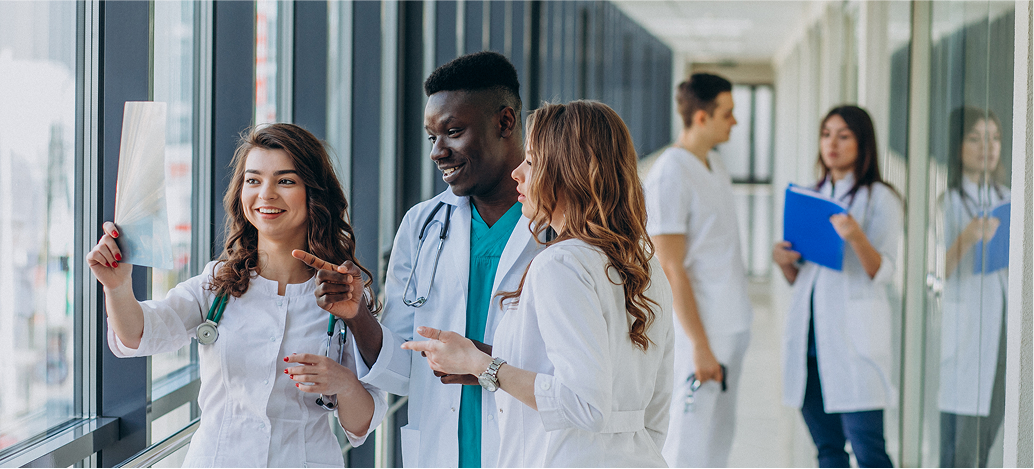 Medical students discussing in hospital corridor