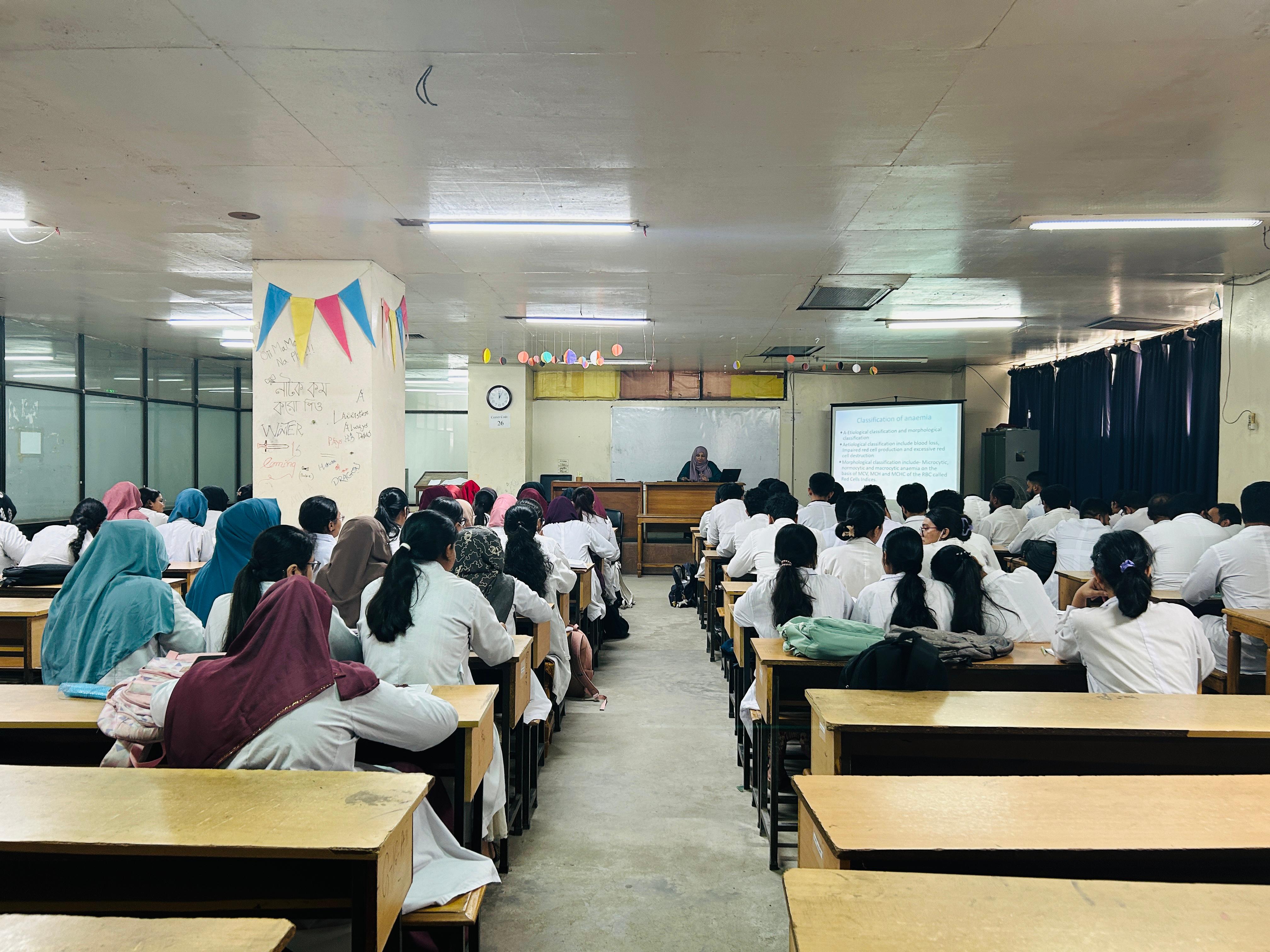 Medical students discussing in hospital corridor